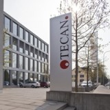 Tecan baut Management um